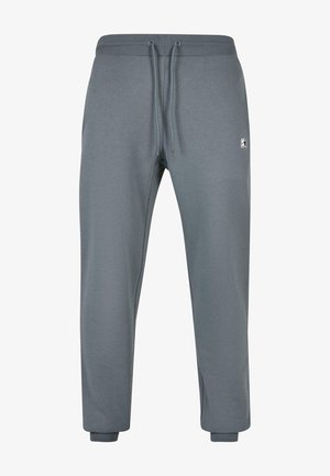 Graue Jogginghosen aus weichem Material, mit elastischem Bund und Kordelzug sowie gerippten Bündchen. Kleines Logo-Detail an der Seite.