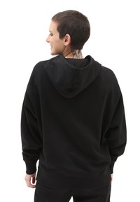Black hoodie made of soft fabric, featuring a spacious fit, drawstring hood, and ribbed cuffs. Plain design with no visible patterns or hardware.