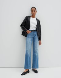 Black faux leather blazer, white crew-neck t-shirt, light blue wide-leg jeans, and black pointed flats. Smooth texture with a structured design.