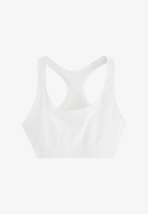 Seno bianco sportivo con texture a costine, design a racerback ampio e silhouette liscia. Il tessuto è elasticizzato e morbido.