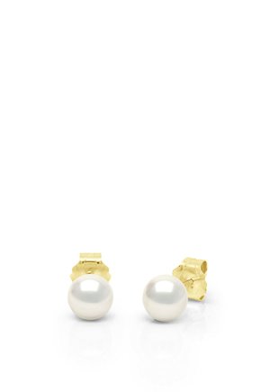 Paire de boucles d'oreilles à puce en perles blanches rondes avec fermoirs papillon en or sur une surface blanche réfléchissante.