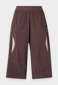 Καφέ παντελόνι με φαρδύ και κομμένο μήκος, ελαστική μέση και μπεζ πλαϊνές ρίγες, με τσεπάκια με φερμουάρ και στις δύο πλευρές.