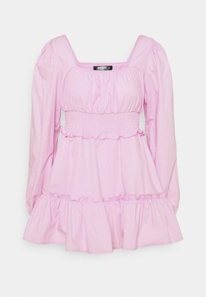 Pink cotton dress with long puff sleeves, square neckline, and smocked waist. Features ruffled hem and lightweight texture.