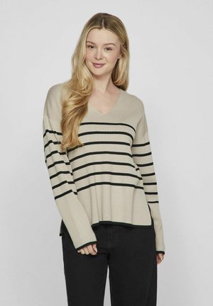 Jersey beige de cuello en V con rayas horizontales negras, mangas largas y un ajuste relajado. Fabricado con un material suave de textura lisa.