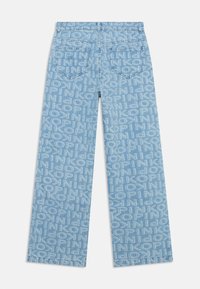 Light blue denim jeans with an all-over text pattern. Features two back pockets, straight leg design, and subtle stitching details.