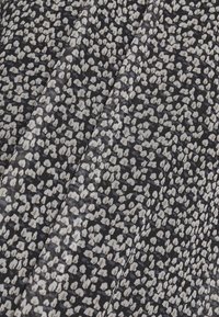 Tissu texturé avec un fond bleu marine foncé, présentant un motif abstrait gris clair éparpillé. Le matériau semble léger et tissé.