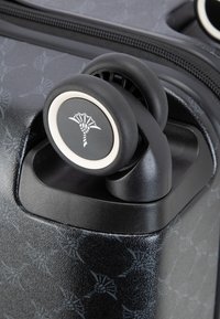 Schwarzer Hartschalenkoffer mit einer strukturierten Oberfläche und einem dezenten Muster, ausgestattet mit doppelten Spinner-Rädern und einem Logodetail.