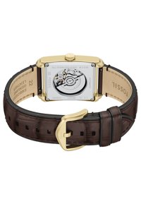 Automatische polshorloge met een rechthoekige kast van goud roestvrij staal, een bruine lederen band van echt leer en een zichtbaar uurwerk aan de achterkant.