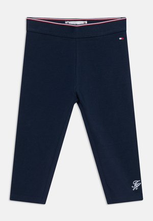 Marineblå leggings for småbarn med elastisk midjebånd, prydet med rødt, hvitt og blått stripet kantbånd og liten brodert logo nær kanten og midjen.
