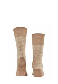 Beige Socken mit strukturiertem Muster und festem Bündchen. Mit geripptem Design und Logo an der Zehe. Weiches Material mit sauberem Finish.