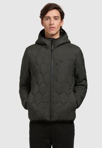 Padded green jacket with a hexagonal quilted pattern, zippered front, adjustable hood, and a chest pocket. Smooth texture, casual design.