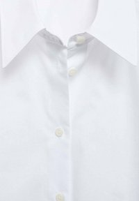 White cotton dress shirt with a classic point collar, featuring a row of three white buttons and smooth texture, no patterns or designs.