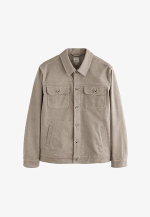 Giacca in corduroy beige con taglio dritto, dotata di colletto a punta, due tasche sul petto e tasche laterali per le mani.