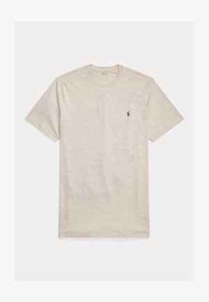 Svetlo bež kratka majica s kratkimi rokavi iz mehke bombažne tkanine, s klasičnim okroglim izrezom in majhnim vezenim logotipom na prsih.