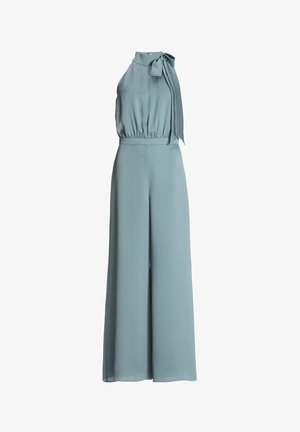Light blue jumpsuit with a high neck, shoulder tie, and wide-leg design. Made of textured fabric with an elastic waistband.