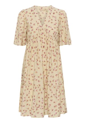 Cve�čni top zlahka bež barve z kratkimi napihnjenimi rokavi, V-izrezom, nabranim korpusom in večplastno krilo, ki ima vzorce rož v rožnati in vijolični barvi.