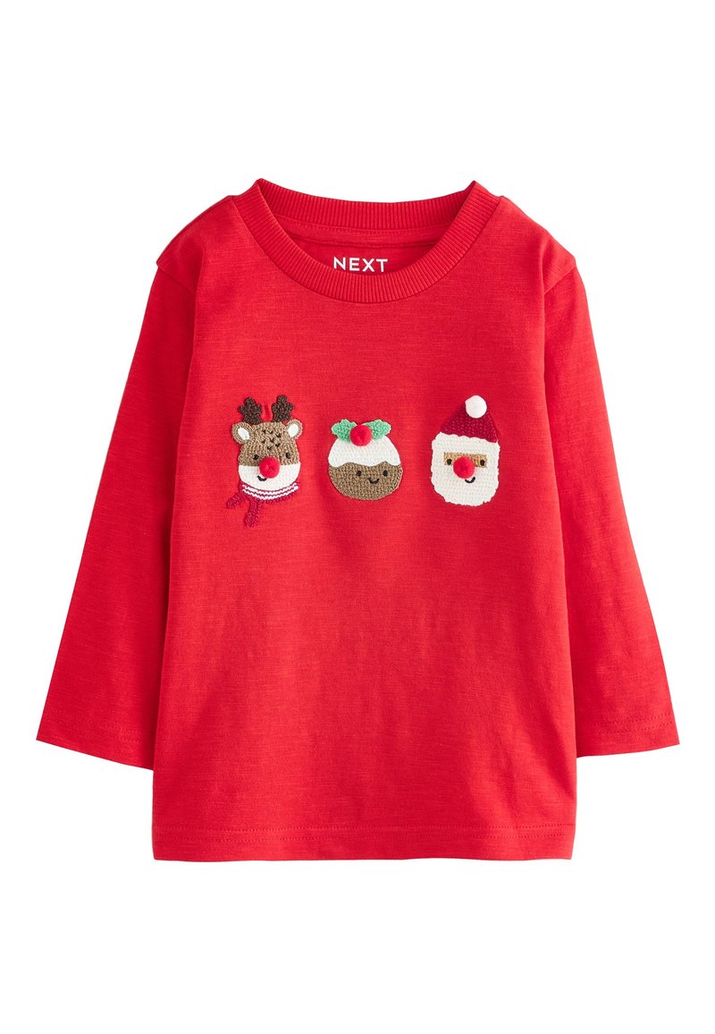 Chemise rouge à manches longues ornée de motifs brodés représentant un renne, un pudding de Noël et le Père Noël. Tissu doux avec un col rond.