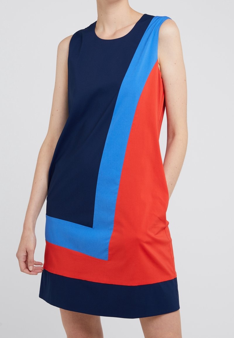Sleeveless dress featuring navy, red, and blue color blocks. Smooth, lightweight fabric with a relaxed fit and rounded neckline.