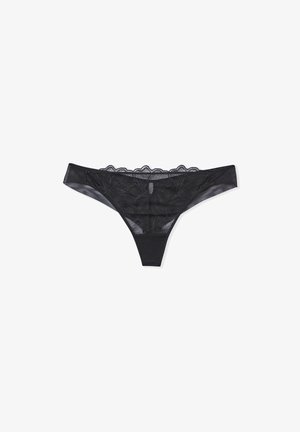 Schwarzes Spitzen-Thong mit floralen Mustern, transparentem Netzstoff und gewellten Kanten. Insgesamt einfaches und minimalistisches Design.