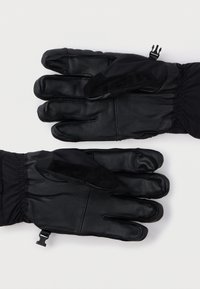 Luvas de couro pretas com acabamento texturizado e punhos elásticos. Inclui um detalhe liso em preto no polegar para uso em tela sensível ao toque.