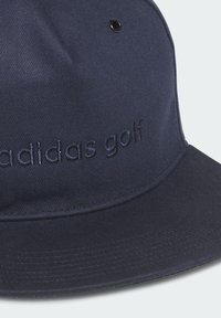 Navy blue cap made of durable fabric, features embroidered "adidas golf" logo, structured design, and a flat brim with ventilation eyelet.