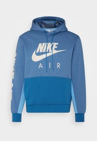 Nike-hoodie i olika nyanser av blått. Har en känguruficka, dragsko i huvan och tryckt logotyp med "AIR" på framsidan. Mjuk tyg.