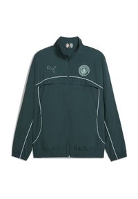 Dunkelgrüne Windjacke mit weißen Akzenten, ausgestattet mit einem Frontreißverschluss, hohem Kragen und dem Logo von Manchester City auf der Brust.