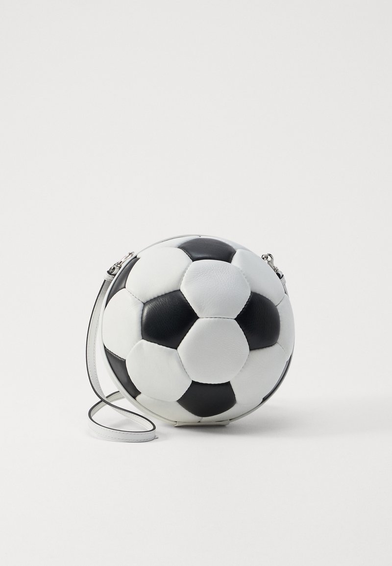Black and white spherical handbag resembling a soccer ball, made of synthetic leather with a detachable strap and hexagonal panel design.