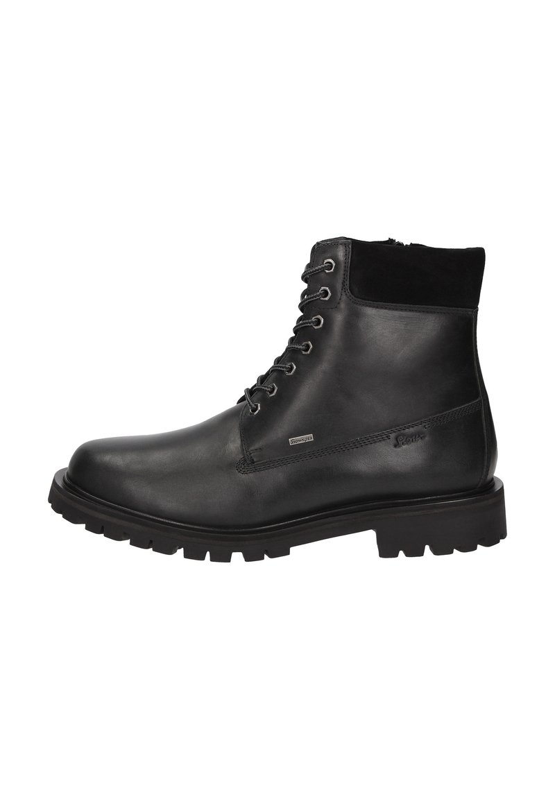 Stivali alla caviglia in pelle nera con colletto in camoscio testurizzato, punta rotonda e suola in gomma robusta. Presentano occhielli in metallo e design con lacci.