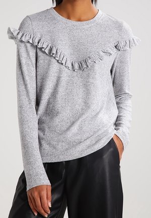 Graues Langarmshirt mit strukturiertem Finish und Rüschendetails am Halsauschnitt. Weicher Stoff, lockere Passform.