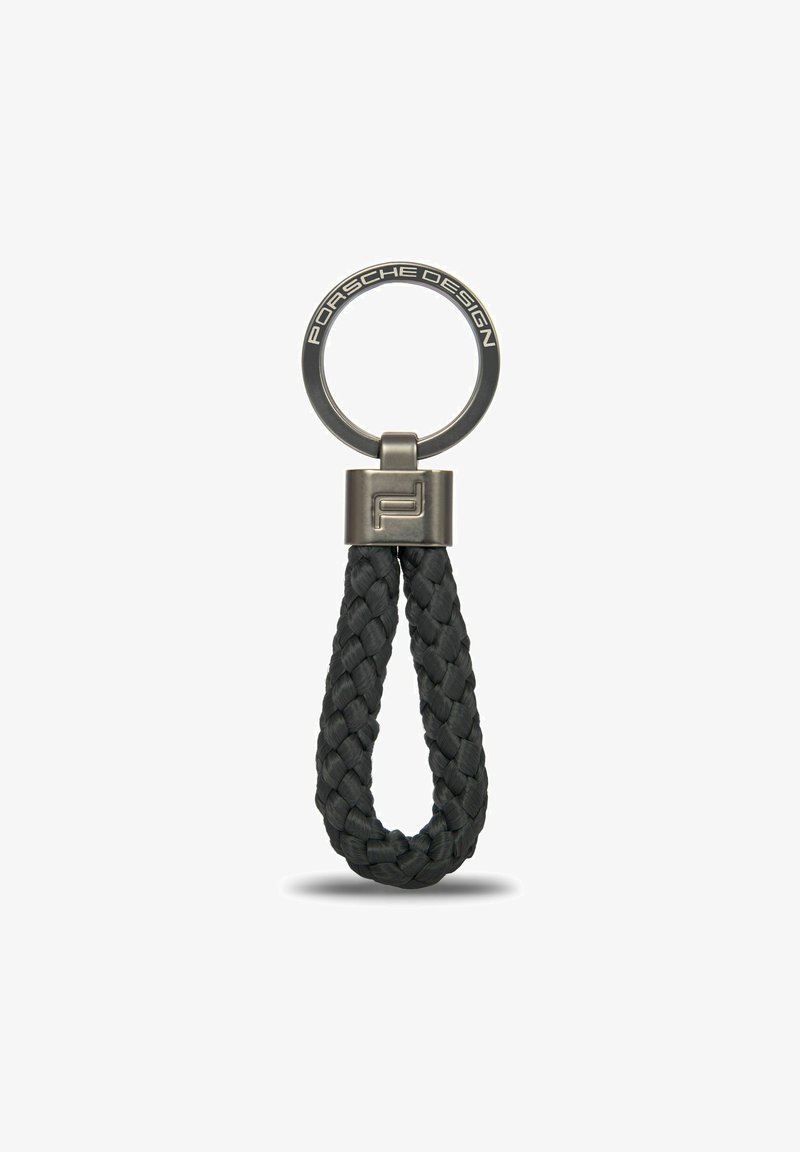 Llavero de cuero trenzado negro con anilla metálica, que presenta un logotipo circular de Porsche Design y un diseño elegante y minimalista.