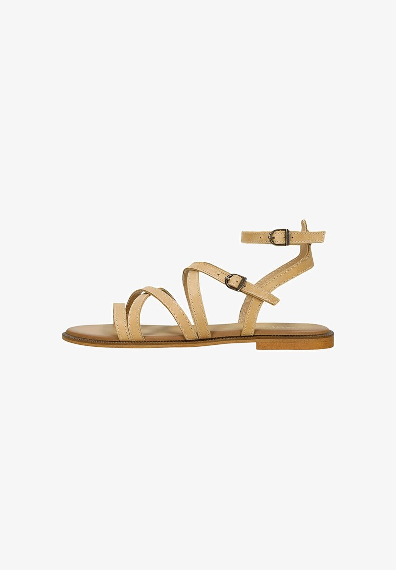 Beżowe sandały na paski z wieloma nachodzącymi na siebie paskami, regulowanym zapięciem na kostce i płaską podeszwą. Gładka skórzana faktura i minimalistyczny design.