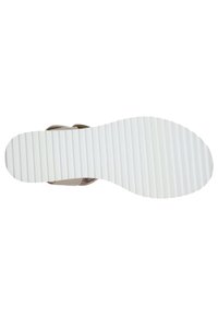Calzature con una tomaia beige e una suola in gomma bianca caratterizzata da scanalature orizzontali per una migliore aderenza e un design semplice e pulito.