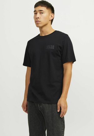 Black cotton t-shirt with short sleeves, featuring a small, tonal Jack & Jones logo on the left chest. Simple, straight-cut design.
