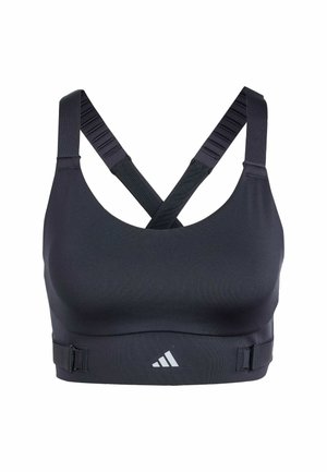 Sujetador deportivo negro con tirantes cruzados en la espalda, textura de tela suave, banda ajustable y un pequeño logo blanco en la parte inferior.