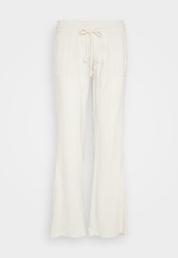 Pantalons blancs en lin avec une taille élastique et un cordon de serrage à l'avant, présentant une coupe décontractée et des poches latérales.