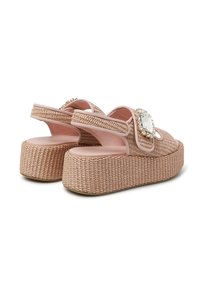 Woven pink platform sandals with a chunky base, decorative rectangular gem accents, and an open back design for easy wear.