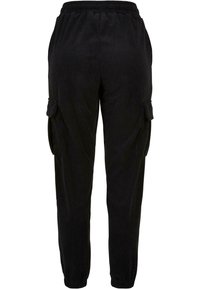 Pantalon cargo en velours côtelé noir avec taille élastique, poches à rabat latérales et poignets élastiques aux chevilles.