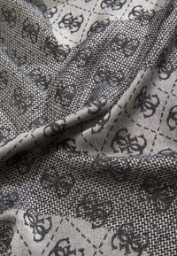 Black and gray fabric with a houndstooth pattern, featuring intricate floral motifs. Lightweight, soft texture with a woven appearance.