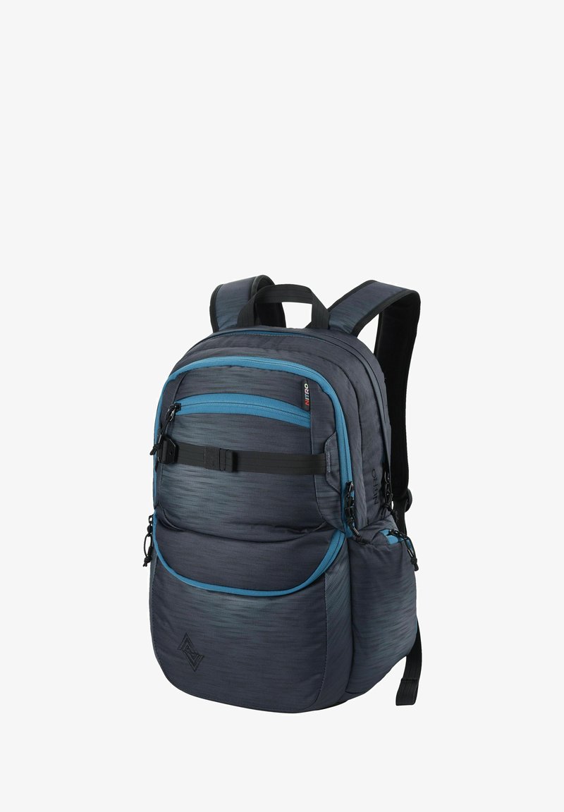 Gray fabric backpack with blue accents, multiple zippered pockets, padded back and straps, and a textured design. Features adjustable hardware.