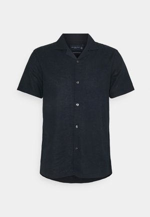 Chemise noire à manches courtes avec boutons, col camp et ourlet légèrement courbé.