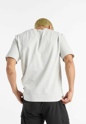 Light gray, short-sleeved t-shirt with a relaxed fit, crafted from soft cotton blend, features a rounded neckline and back seam detail.
