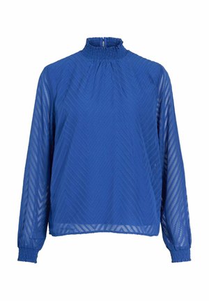 Mėlyna bliuska, pagaminta iš permatomo audinio, su aukštu kaklu, ilgomis rankovėmis ir tekstūrine žalvario raštu. Yra gumelės rankogaliai ir kaklas.