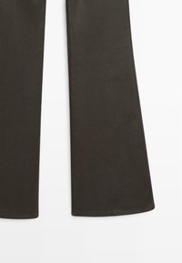 Dark brown wide-leg pant legs shown from mid-thigh to hem on a white background.