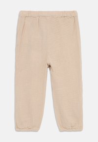 Beige, lette bukser laget av teksturert stoff, med elastisk midje og innsamlede ankelmansjetter for en avslappet passform.