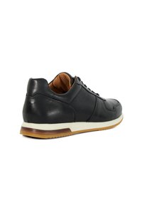 Black leather sneaker with textured panels, round toe, white midsole, and brown rubber outsole. Features lace-up closure and cushioned collar.
