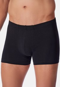 Boxer shorts neri in cotone, con una cintura morbida, forma aderente e una texture liscia per il massimo comfort; senza motivi o accenti visibili.
