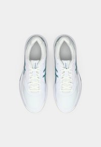 Hvite sportsko med mesh-overdel, med teal-detaljer og rund tå. Snøring med polstret tunge og krage.