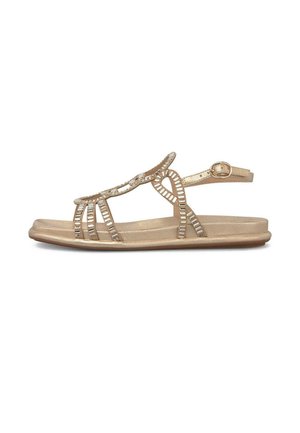 Sandalia plana dorada con punta abierta, tiras decorativas de strass y hebilla ajustable en el tobillo sobre fondo blanco.