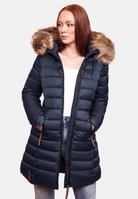 Navy puffer coat with a fur-lined hood, featuring quilted texture, zip closure, and side pockets with brown accents.